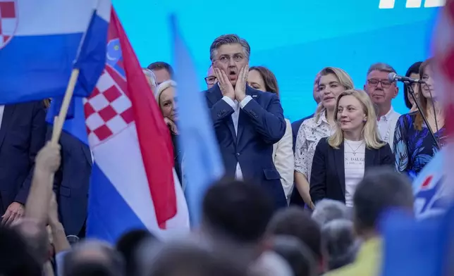 Prime Minister incumbent Andrej Plenkovic, centre, attends his party's rally in Zagreb, Croatia, Sunday, April 14, 2024. Croatia this week holds an early parliamentary election following a campaign that was marked by heated exchanges between the country's two top officials, creating a political crisis in the Balkan country, a European Union and NATO member state. (AP Photo/Darko Bandic)