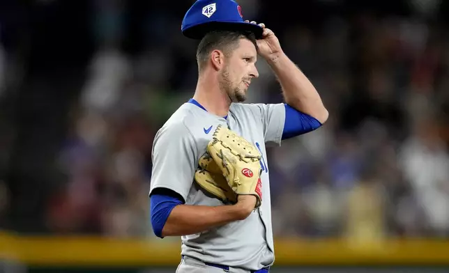 Chicago Cubs pitcher Drew Smyly adjusts his cap after giving up a run against the Arizona Diamondbacks during the eighth inning of a baseball game, Monday, April 15, 2024, in Phoenix. (AP Photo/Matt York)