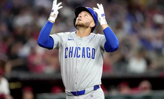 Chicago Cubs' Michael Busch crosses the plate after hitting a solo home run against the Arizona Diamondbacks during the second inning of a baseball game, Monday, April 15, 2024, in Phoenix. (AP Photo/Matt York)
