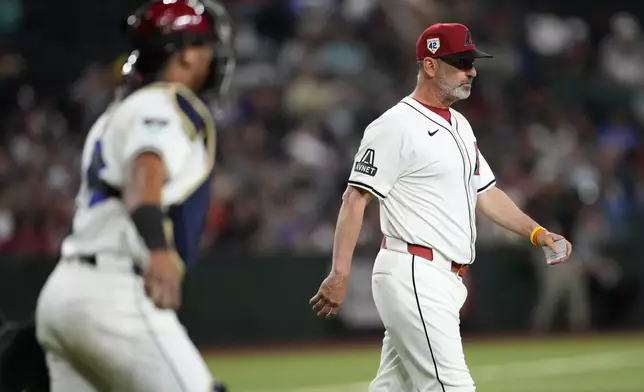 Arizona Diamondbacks manager Tory Lovell walks to the mound during the seventh inning of a baseball game against the Chicago Cubs, Monday, April 15, 2024, in Phoenix. (AP Photo/Matt York)