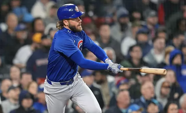 Chicago Cubs' Patrick Wisdom follows through on a two-run double during the seventh inning of a baseball game against the Boston Red Sox, Friday, April 26, 2024, in Boston. (AP Photo/Michael Dwyer)
