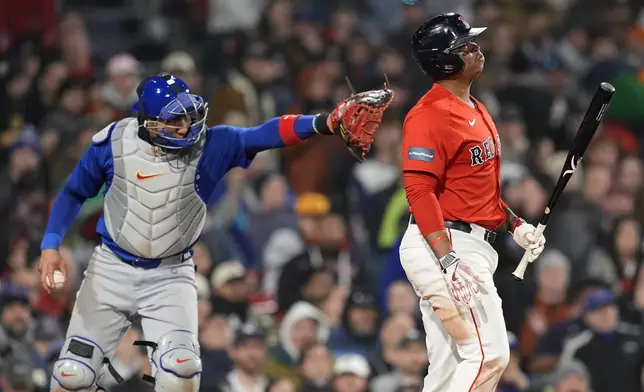 Boston Red Sox's Rafael Devers, right, reacts in front of Chicago Cubs catcher Miguel Amaya, left, after striking out swinging during the sixth inning of a baseball game, Friday, April 26, 2024, in Boston. (AP Photo/Michael Dwyer)