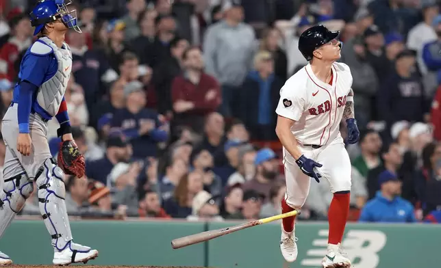 Boston Red Sox's Tyler O'Neill, right, watches his walkoff RBI single in front of Chicago Cubs catcher Miguel Amaya, left, during the ninth inning of a baseball game, Sunday, April 28, 2024, in Boston. (AP Photo/Michael Dwyer)