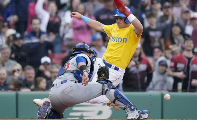 Boston Red Sox's Bobby Dalbec scores on a three-run double by Ceddanne Rafaela as Chicago Cubs catcher Yan Gomes reaches for the late throw during the fifth inning of a baseball game, Saturday, April 27, 2024, in Boston. (AP Photo/Michael Dwyer)
