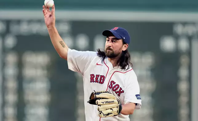 Singer/songwriter Noah Kahan throws a ceremonial first pitch before a baseball game between the Boston Red Sox and the Chicago Cubs, Sunday, April 28, 2024, in Boston. (AP Photo/Michael Dwyer)