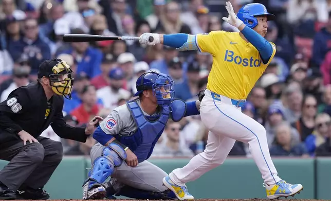 Boston Red Sox's Masataka Yoshida, right, follows through on his single in front of Chicago Cubs catcher Yan Gomes, center, during the second inning of a baseball game, Saturday, April 27, 2024, in Boston. (AP Photo/Michael Dwyer)