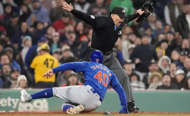 Chicago Cubs' Mike Tauchman (40) scores on a sacrifice fly by Michael Busch during the fifth inning of the team's baseball game against the Boston Red Sox, Friday, April 26, 2024, in Boston. (AP Photo/Michael Dwyer)