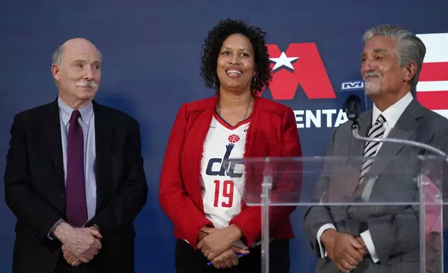 Ted Leonsis, right, owner of the Washington Wizards NBA basketball team and Washington Capitals NHL hockey team with Washington DC Mayor Muriel Bowser, center, and DC Council Chairman Phil Mendelson, left, during a news conference at Capitol One Arena in Washington, Wednesday, March 27, 2024. (AP Photo/Stephanie Scarbrough)