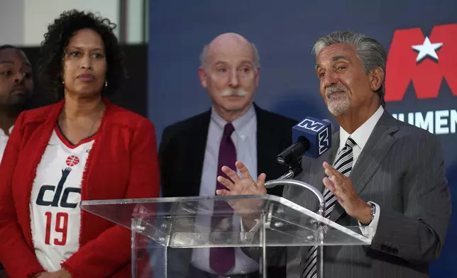 Ted Leonsis, right, owner of the Washington Wizards NBA basketball team and Washington Capitals NHL hockey team, speaks during a news conference with Washington DC Mayor Muriel Bowser, left, and DC Council Chairman Phil Mendelson, center, at Capitol One Arena in Washington, Wednesday, March 27, 2024. (AP Photo/Stephanie Scarbrough)