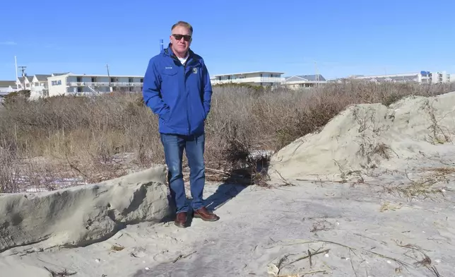 FILE - Mayor Patrick Rosenello stands next to a destroyed section of sand dune in North Wildwood N.J. Jan. 22, 2024. On April 25, 2024, North Wildwood and the state of New Jersey announced an agreement for an emergency beach replenishment project there to protect the city until a full-blown beach fill can be done by the U.S. Army Corps of Engineers that may still be two years away. Winter storms punched a hole through what is left of the city's eroded dune system, leaving it more vulnerable than ever to destructive flooding. (AP Photo/Wayne Parry, File)