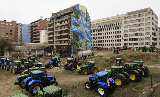 FILE - Farmers park their tractors near the European Council building in Brussels during a demonstration on March 26, 2024. Across the EU, long convoys of tractors have cut off economic lifelines like ports and beltways around major cities, sometimes for days on end, with costs to industry running into the tens of millions daily and keeping hundreds of thousands of people from going to work. (AP Photo/Geert Vanden Wijngaert, File)