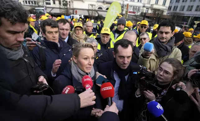 FILE - Marion Marechal, Marine Le Pen's niece and Executive Vice President of French far-right party 'Reconquete', center, speaks with farmers and journalists during a demonstration of French and Belgian farmers outside the European Parliament in Brussels, on Jan. 24, 2024. (AP Photo/Virginia Mayo, File)