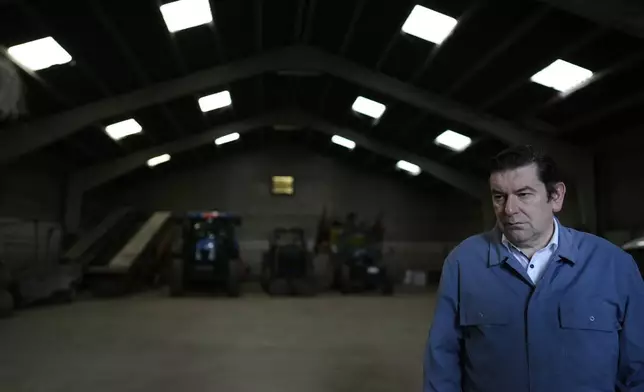 FILE - Belgian Farmer and politician, Bart Dochy, stands in front of tractors in a barn at his family farm in Ledegem, Belgium, on Feb. 13, 2024. As the Christian Democrat mayor of the farming town of Ledegem and a parliamentarian, Dochy represents the powers that have always been dominant in farming communities for centuries in large swathes of Europe, Christian and Conservative. (AP Photo/Virginia Mayo, File)
