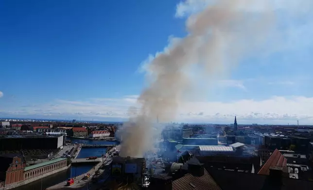 Smoke rises out of the Old Stock Exchange, Boersen, in Copenhagen, Denmark, Tuesday, April 16, 2024. One of Copenhagen’s oldest buildings is on fire and its iconic spire has collapsed. The copper roof of the 17th-century Old Stock Exchange, or Boersen, that was once Denmark’s financial center, was engulfed in flames Tuesday. (Ida Marie Odgaard/Ritzau Scanpix via AP)