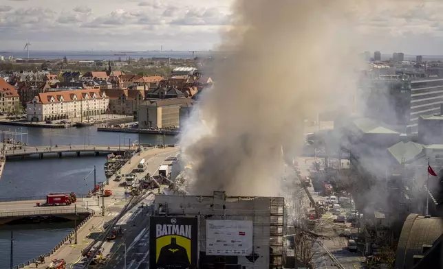 Smoke rises from the Stock Exchange in Copenhagen, Denmark, Tuesday, April 16, 2024. A fire raged through one of Copenhagen’s oldest buildings on Tuesday, causing the collapse of the iconic spire of the 17th-century Old Stock Exchange as passersby rushed to help emergency services save priceless paintings and other valuables. (Ida Marie Odgaard/Ritzau Scanpix via AP)