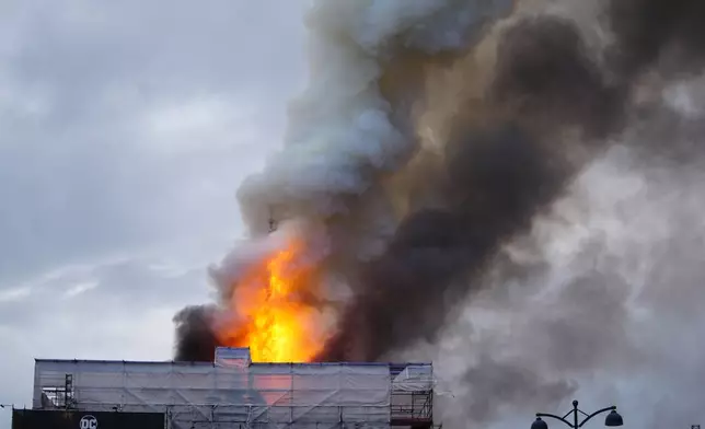 Fire and smoke rise out of the Old Stock Exchange, Boersen, in Copenhagen, Denmark, Tuesday, April 16, 2024. (Ida Marie Odgaard/Ritzau Scanpix via AP)