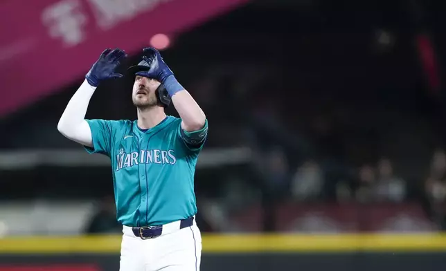 Seattle Mariners' Mitch Garver reacts after hitting a double against the Arizona Diamondbacks during the fifth inning of a baseball game Saturday, April 27, 2024, in Seattle. (AP Photo/Lindsey Wasson)
