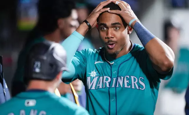 Seattle Mariners' Julio Rodríguez, right, reacts after Ty France, left, hit a two-run home run against the Arizona Diamondbacks during the seventh inning of a baseball game Saturday, April 27, 2024, in Seattle. (AP Photo/Lindsey Wasson)