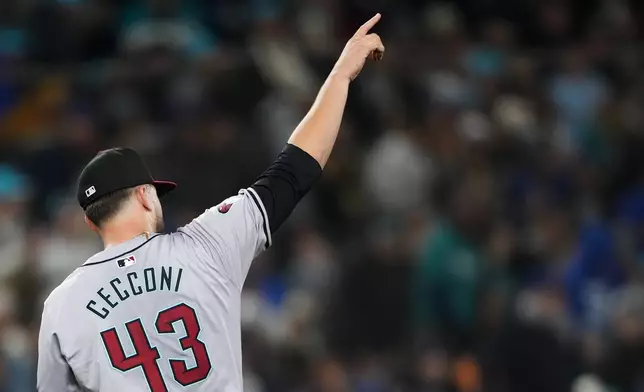 Arizona Diamondbacks starting pitcher Slade Cecconi points to center fielder Corbin Carroll after Carroll caught a long fly ball hit by Seattle Mariners' Josh Rojas during the fifth inning of a baseball game Saturday, April 27, 2024, in Seattle. (AP Photo/Lindsey Wasson)