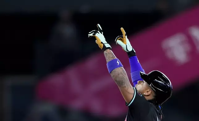 Arizona Diamondbacks' Ketel Marte points after hitting an RBI double against the Seattle Mariners during the eighth inning of a baseball game Sunday, April 28, 2024, in Seattle. (AP Photo/Lindsey Wasson)
