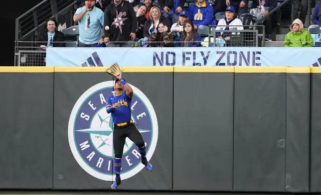 Seattle Mariners center fielder Julio Rodríguez catches a fly ball from Arizona Diamondbacks' Gabriel Moreno during the fifth inning of a baseball game Friday, April 26, 2024, in Seattle. (AP Photo/Lindsey Wasson)