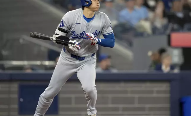 Los Angeles Dodgers designated hitter Shohei Ohtani starts up the base path after hitting a line drive to second base during fourth-inning baseball game action against the Toronto Blue Jays in Toronto, Sunday, April 28, 2024. (Frank Gunn/The Canadian Press via AP)