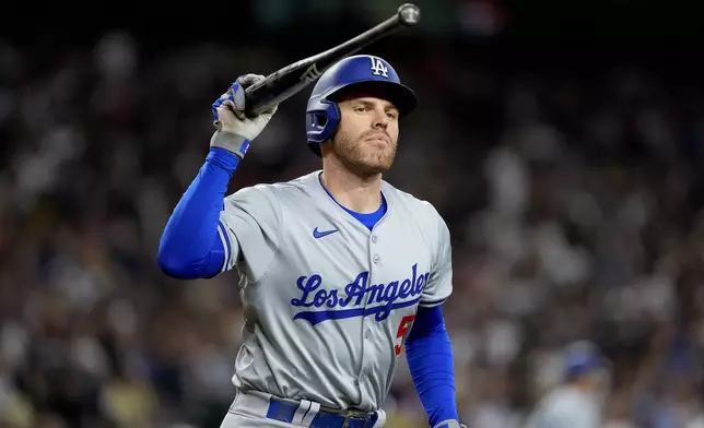 Los Angeles Dodgers' Freddie Freeman throws his bat after hitting a fly out during the eighth inning of a baseball game against the Arizona Diamondbacks, Monday, April 29, 2024, in Phoenix. (AP Photo/Matt York)