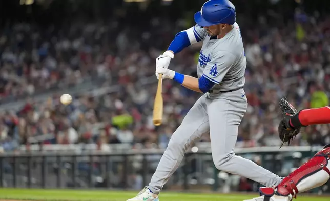 Los Angeles Dodgers' Gavin Lux hits a two-run single during the fifth inning of the team's baseball game against the Washington Nationals at Nationals Park, Wednesday, April 24, 2024, in Washington. (AP Photo/Alex Brandon)