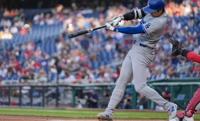 Los Angeles Dodgers designated hitter Shohei Ohtani hits a double against the Washington Nationals during the first inning of a baseball game at Nationals Park, Wednesday, April 24, 2024, in Washington. (AP Photo/Alex Brandon)