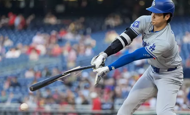 Los Angeles Dodgers designated hitter Shohei Ohtani breaks his bat during the first inning of a baseball game against the Washington Nationals at Nationals Park, Tuesday, April 23, 2024, in Washington. (AP Photo/Alex Brandon)