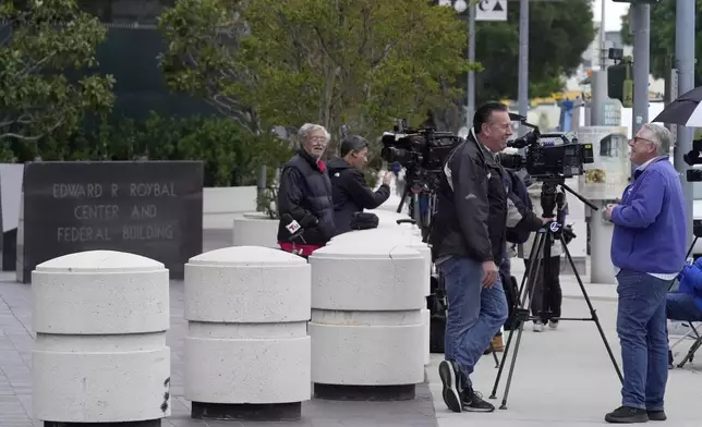 News crews wait outside federal court for Ippei Mizuhara, the former longtime interpreter for Los Angeles Dodgers star Shohei Ohtani, Friday, April 12, 2024, in Los Angeles. Mizuhara is charged with federal bank fraud, alleging that he stole more than $16 million from the Japanese sensation to cover gambling bets and debts, federal authorities said. (AP Photo/Damian Dovarganes)
