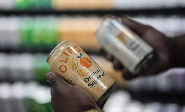 Cans of Olipop, a soda containing botanicals, plant fibers, and prebiotics, are shown at a Kroger supermarket, Friday, April 12, 2024, in Marietta, Ga. U.S. sales of prebiotic and probiotic drinks more than tripled last year. (AP Photo/Mike Stewart)