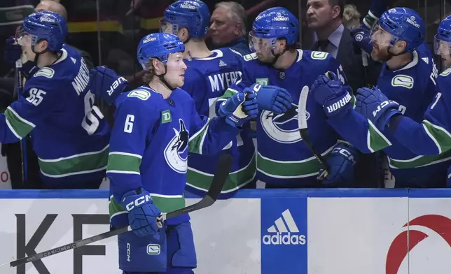 Vancouver Canucks' Brock Boeser (6) is congratulated for a goal against the Anaheim Ducks during the first period of an NHL hockey game Sunday, March 31, 2024, in Vancouver, British Columbia. (Darryl Dyck/The Canadian Press via AP)