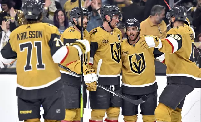 The Vegas Golden Knights celebrate a goal by Jack Eichel, center, against the Anaheim Ducks during the second period of an NHL hockey game Thursday, April 18, 2024, in Las Vegas. (AP Photo/David Becker)