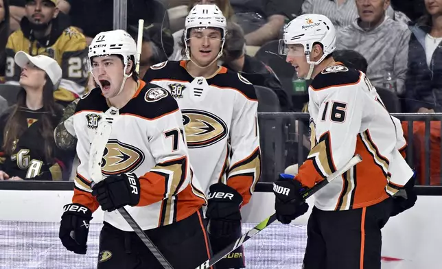 Anaheim Ducks right wing Frank Vatrano (77) celebrates a goal against the Vegas Golden Knights with teammates Trevor Zegras (11) and Ryan Strome (16) during the third period of an NHL hockey game Thursday, April 18, 2024, in Las Vegas. (AP Photo/David Becker)