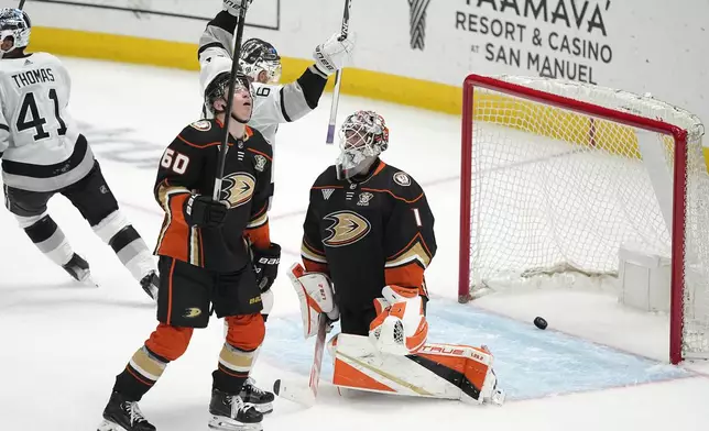 Los Angeles Kings center Trevor Lewis, second from right, celebrates a goal by defenseman Matt Roy as Anaheim Ducks defenseman Jackson LaCombe second from left, and goaltender Lukas Dostal, right, react during the second period of an NHL hockey game Saturday, April 13, 2024, in Los Angeles. (AP Photo/Mark J. Terrill)