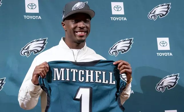 Philadelphia Eagles first-ound draft pick Quinyon Mitchell holds up a jersey during a news conference with the NFL football team in Philadelphia, Friday, April 26, 2024. (AP Photo/Chris Szagola)