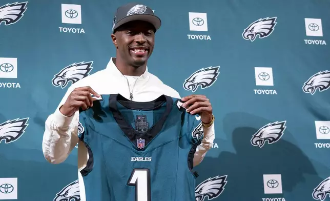 Philadelphia Eagles first round draft pick Quinyon Mitchell holds up his jersey at an NFL football news conference in Philadelphia, Friday, April 26, 2024. (AP Photo/Chris Szagola)
