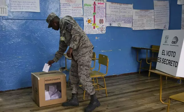 An Air Force soldier votes in a referendum proposed by President Daniel Noboa to endorse new security measures aimed at cracking down on criminal gangs fueling escalating violence, in Quito, Ecuador, Sunday, April 21, 2024. (AP Photo/Dolores Ochoa)