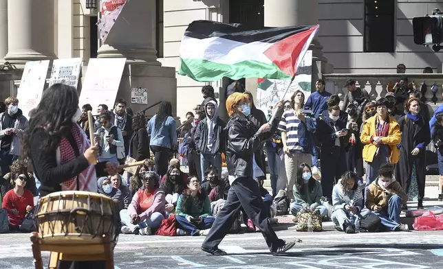 Several hundred students and pro-Palestinian supporters rally at the intersection of Grove and College Streets, in front of Woolsey Hall on the campus of Yale University in New Haven, Conn. April 22, 2024. U.S. colleges and universities are preparing for end-of-year commencement ceremonies with a unique challenge: providing safety for graduates while honoring the free speech rights of students involved in protests over the Israel-Hamas war. (Ned Gerard/Hearst Connecticut Media via AP)