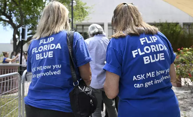 Supporters wear shirts with the message "Flip Florida Blue" while waiting in line to see President Joe Biden speak during a reproductive freedom campaign event at Hillsborough Community College, Tuesday, April 23, 2024, in Tampa, Fla. (AP Photo/Phelan M. Ebenhack)