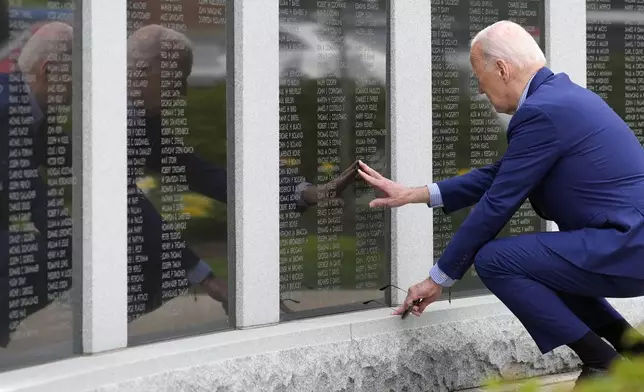 President Joe Biden visits the War Memorial in Scranton, Pa., Wednesday, April 17, 2024, and touches the wall near his uncle's name, Ambrose J Finnegan Jr., who died in WWII. (AP Photo/Alex Brandon)