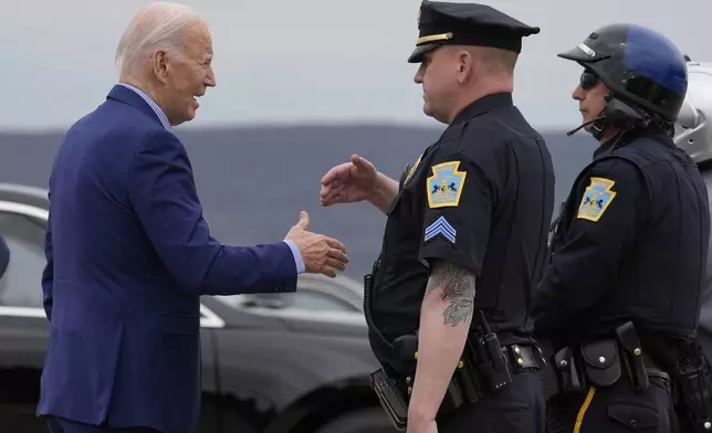 President Joe Biden greets local police officers as he arrives to depart Pennsylvania on Air Force One at Wilkes-Barre Scranton International Airport, Wednesday, April 17, 2024, in Scranton, Pa. (AP Photo/Alex Brandon)