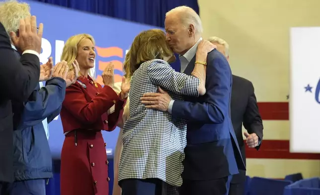 President Joe Biden, right, hugs Kathleen Kennedy Townsend as Kerry Kennedy and members of the Kennedy family look on at a campaign event, Thursday, April 18, 2024, in Philadelphia. (AP Photo/Alex Brandon)