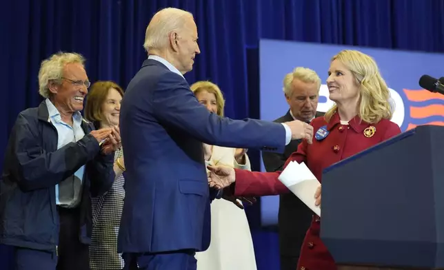 Kerry Kennedy, right, introduces President Joe Biden, third from left, at a campaign event, Thursday, April 18, 2024, in Philadelphia. Pictured from left are members of the Kennedy family Joe Kennedy III, Kathleen Kennedy Townsend, Rory Kennedy and Christopher Kennedy. (AP Photo/Alex Brandon)