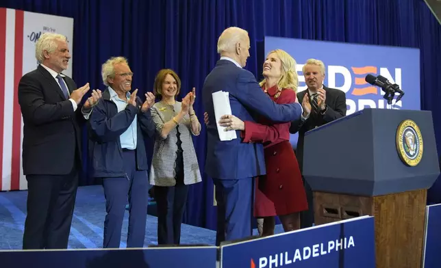 Kerry Kennedy, second from right, hugs President Joe Biden at a campaign event, Thursday, April 18, 2024, in Philadelphia. Pictured from left are members of the Kennedy family Maxwell Kennedy Sr., Joe Kennedy III, Kathleen Kennedy Townsend and Christopher Kennedy. (AP Photo/Alex Brandon)