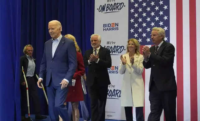 President Joe Biden, second from left, and members of the Kennedy family including Joe Kennedy II, from left, Maxwell Kennedy Sr., Rory Kennedy and Christopher Kennedy walk on stage at a campaign event Thursday, April 18, 2024, in Philadelphia. (AP Photo/Alex Brandon)