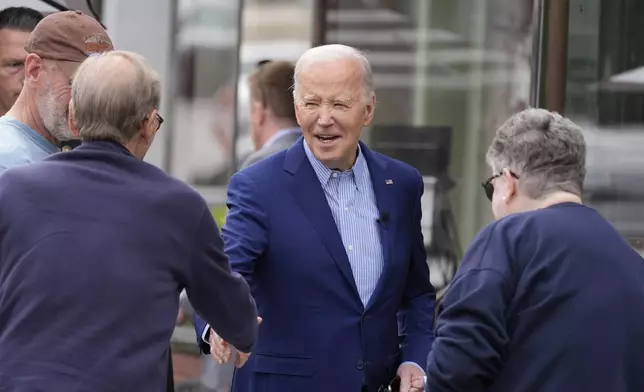 President Joe Biden greets visitors as he visits the War Memorial in Scranton, Pa., Wednesday, April 17, 2024. Biden's uncle, Ambrose J Finnegan Jr., who died in WWII, is listed on the wall. (AP Photo/Alex Brandon)