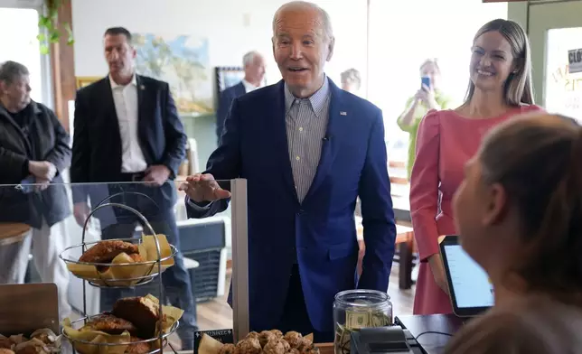 President Joe Biden arrives at Zummo's Cafe, Wednesday morning, April 17, 2024, in Scranton, Pa., with Scranton Mayor Paige Cognetti, right. (AP Photo/Alex Brandon)