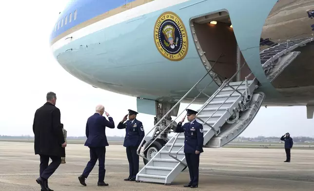 FILE - President Joe Biden, second from left, boards Air Force One, March 28, 2024, at Andrews Air Force Base, Md. Biden is headed to New York for a fundraiser. The White House and the Democratic National Committee are splitting the cost of Biden’s travel while he runs for a second term. It’s part of a longstanding arrangement that prevents taxpayers from being stuck with the full bill for political trips. (AP Photo/Alex Brandon, File)